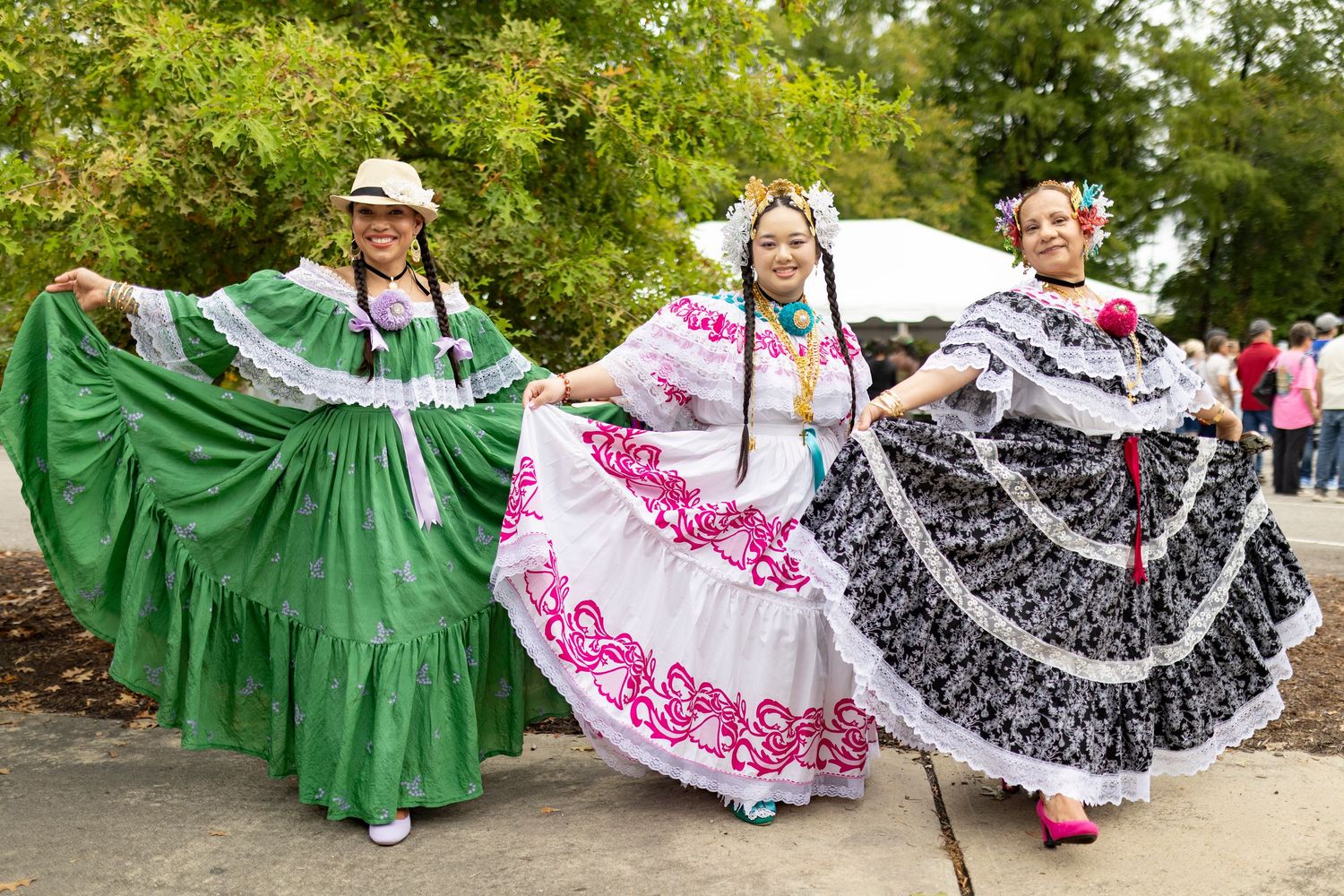 Artistic sequence of a dancer in green dress with yellow fringe performing expressive movements. International Folk Festival, cultural event