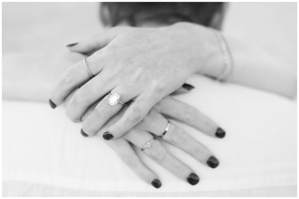 Close-up sequence of hands with black nail polish against white background.