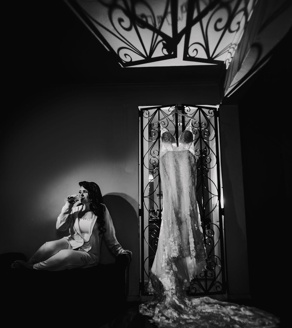 A series of black and white wedding dress photos showing elegant gowns displayed in dramatic lighting and shadows.