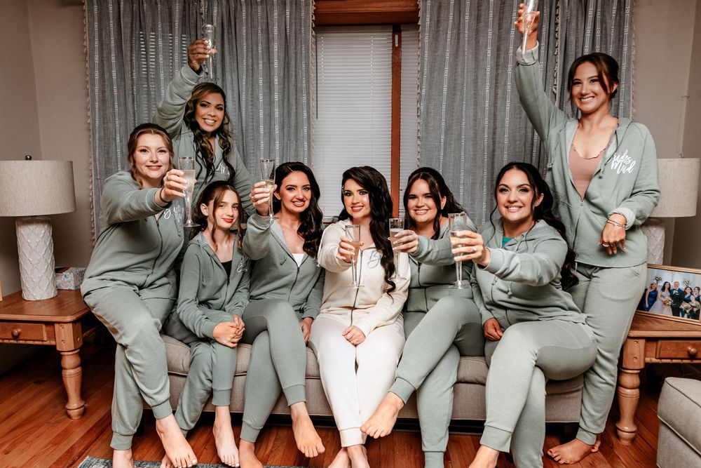 A group in matching sage green outfits poses playfully in a sequence of candid photo moments on a wooden floor.