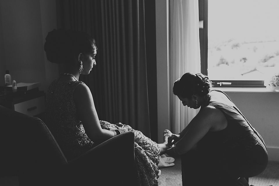 A silhouetted figure sits at a desk in front of a window with natural light streaming in.