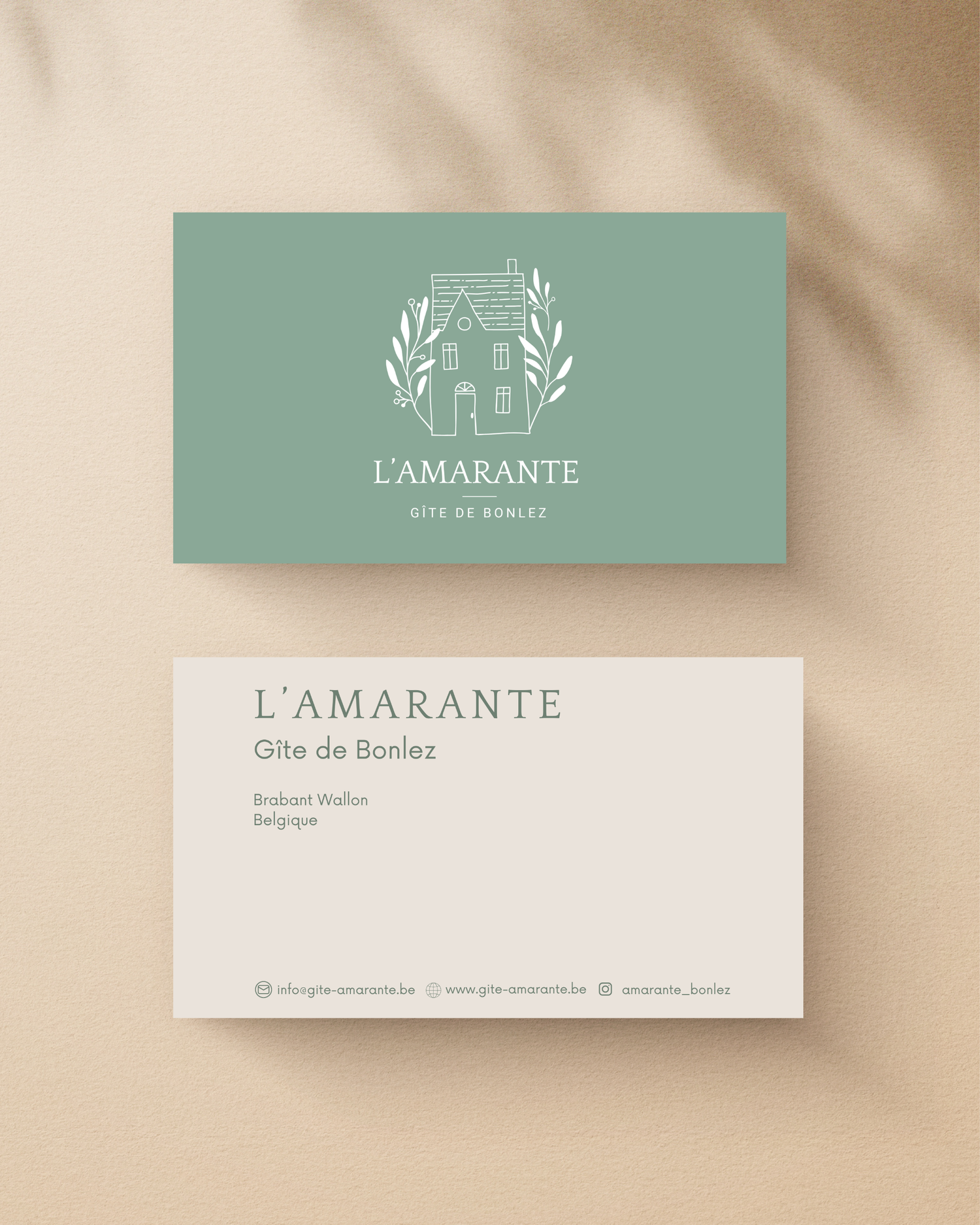 Elegant business cards for L'Amarante featuring a sage green and white color scheme with minimalist house logo design.