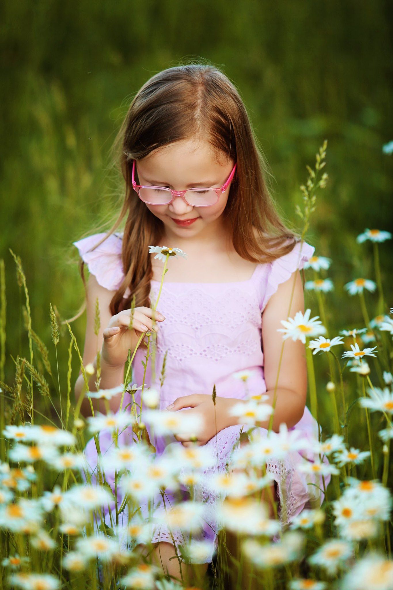 Pink-dressed figure picking daisies in a wildflower meadow wearing glasses.