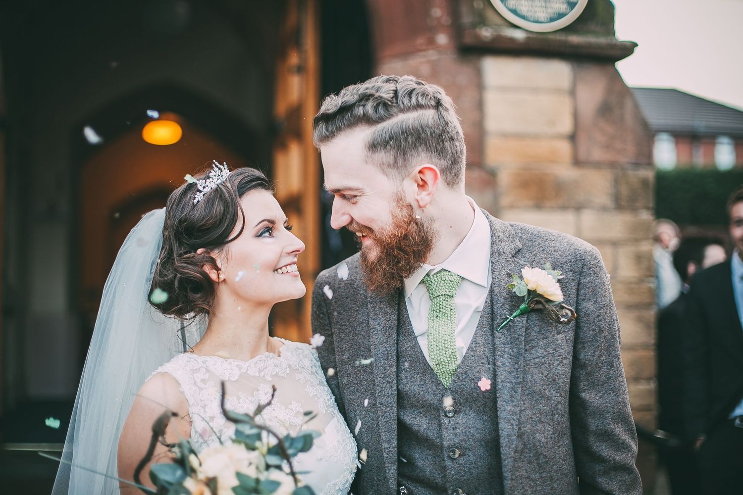 smiling couple look at each other during confetti