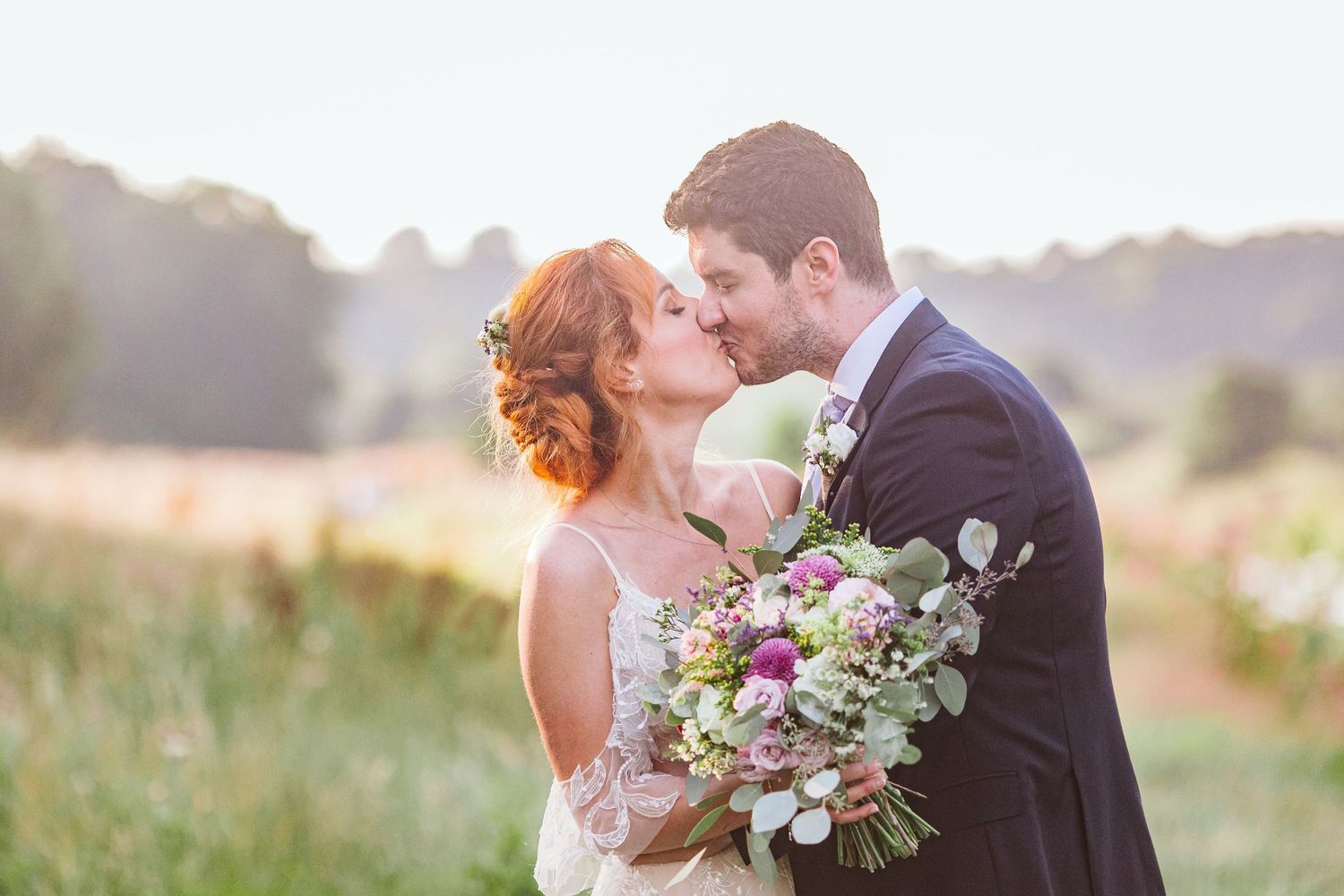 bride and groom kiss at sunset at brockholes nature reserve