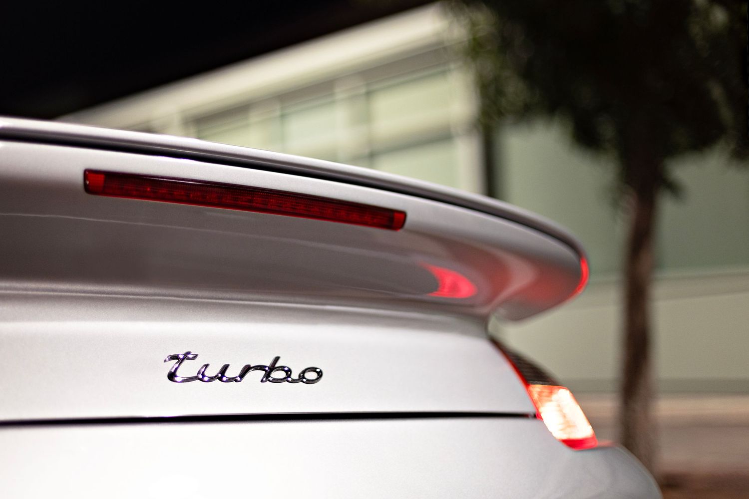 Close up detail of Turbo badging on a Porsche rear spoiler.