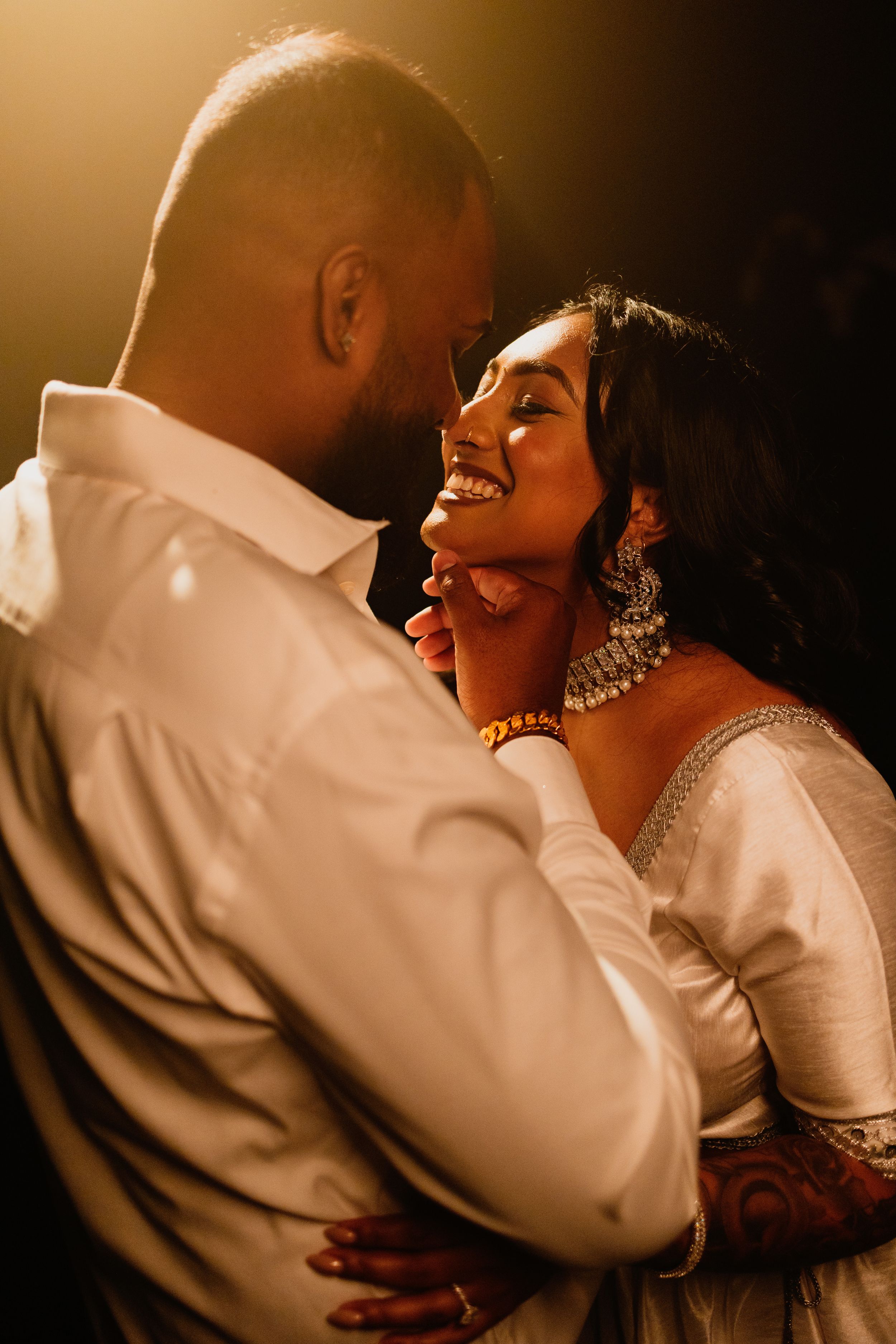 A joyful moment between a couple during their wedding celebration.