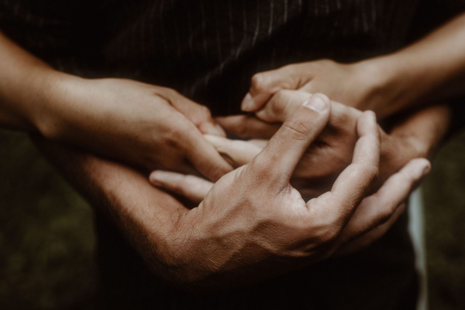A close-up shot of hands exchanging wedding rings during an outdoor ceremony. Taken during a ceremony by Tenerife Wedding Photographer