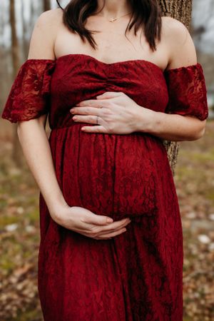 Maternity woman holding belly for maternity photoshoot. Captured by Maryland maternity Photographer Mallory Bramlett.