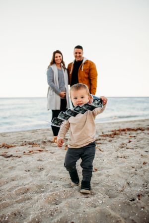 Toddler holding ultrasound picture for maternity pregnancy announcement photo. Captured by Maryland Photographer Mallory Bramlett.