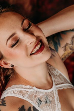 Closeup beauty portrait showing natural makeup, red lipstick and delicate lace details. Grand Rapids Nice and Naughty Store Boudoir Marathon