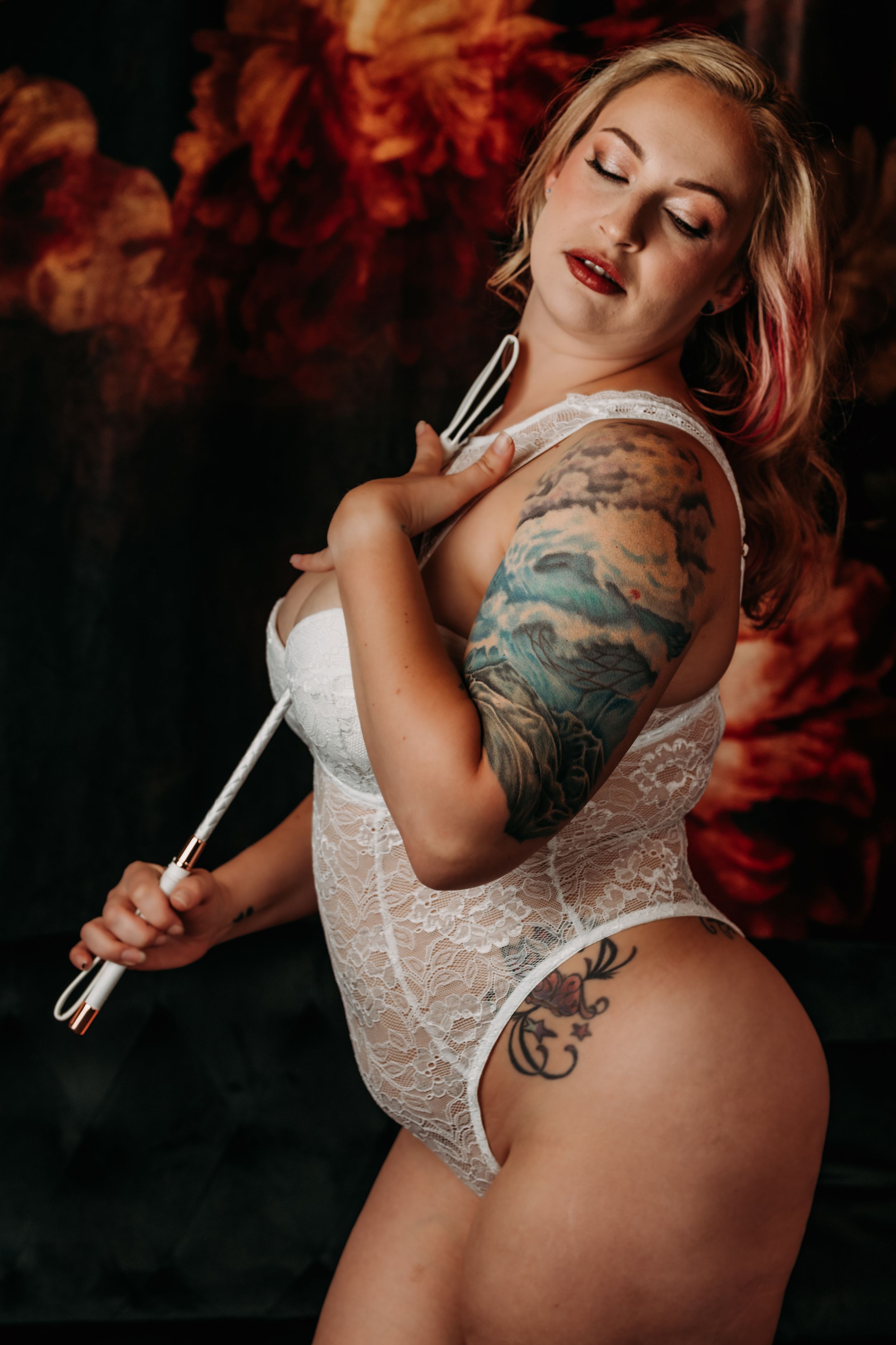 Artistic boudoir photo with dramatic lighting and white ribbon prop. Grand Rapids Nice and Naughty Store Boudoir Marathon Boudoir Photoshoot