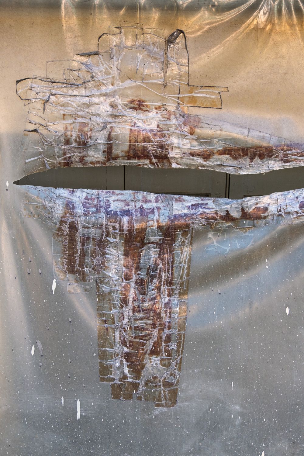 Abstract modern art installation with silver reflective panels suspended in a gallery space creating a mirrored effect.