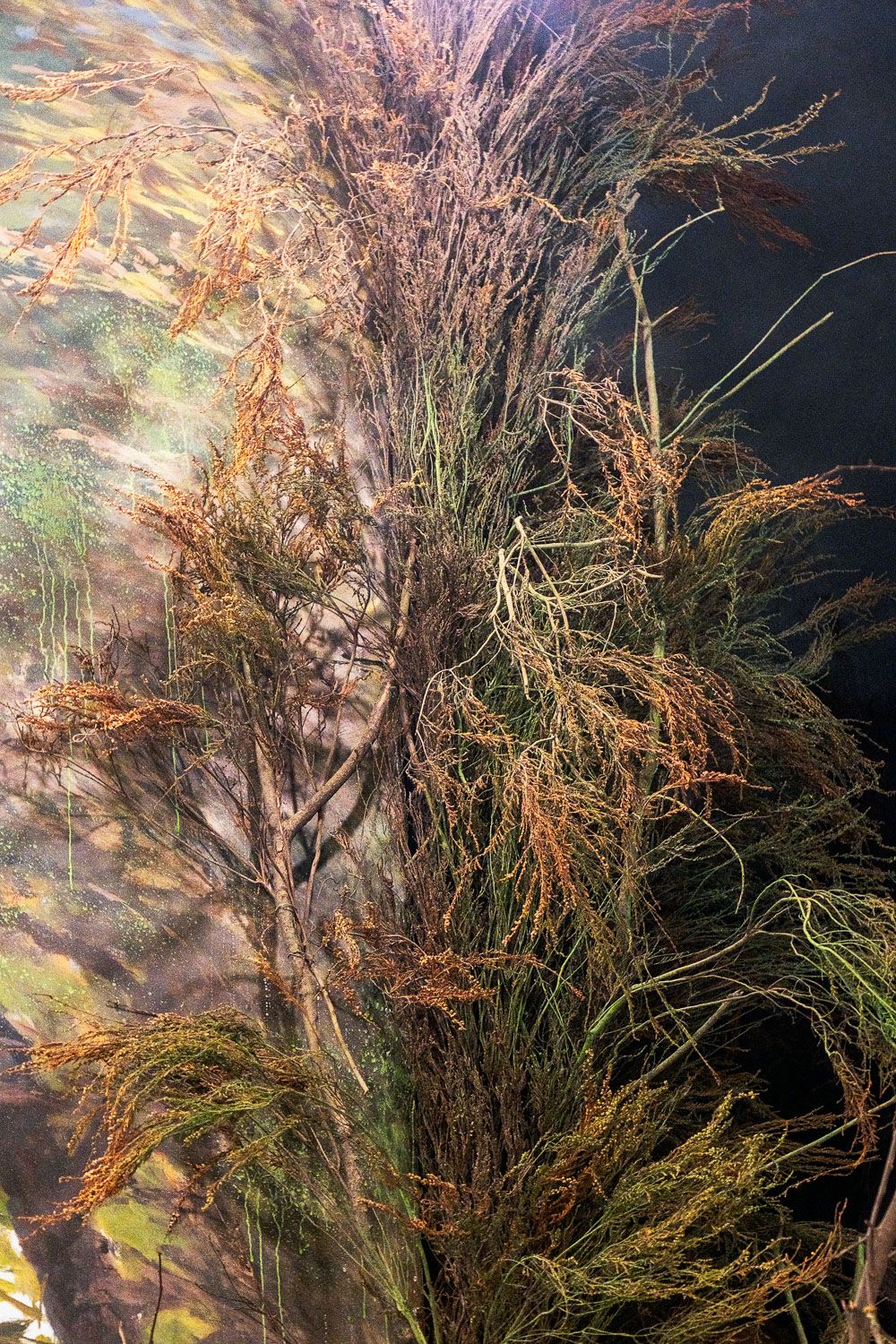 Tangled roots and branches of underwater vegetation sway in the dark depths with ethereal lighting creating a mystical scene.