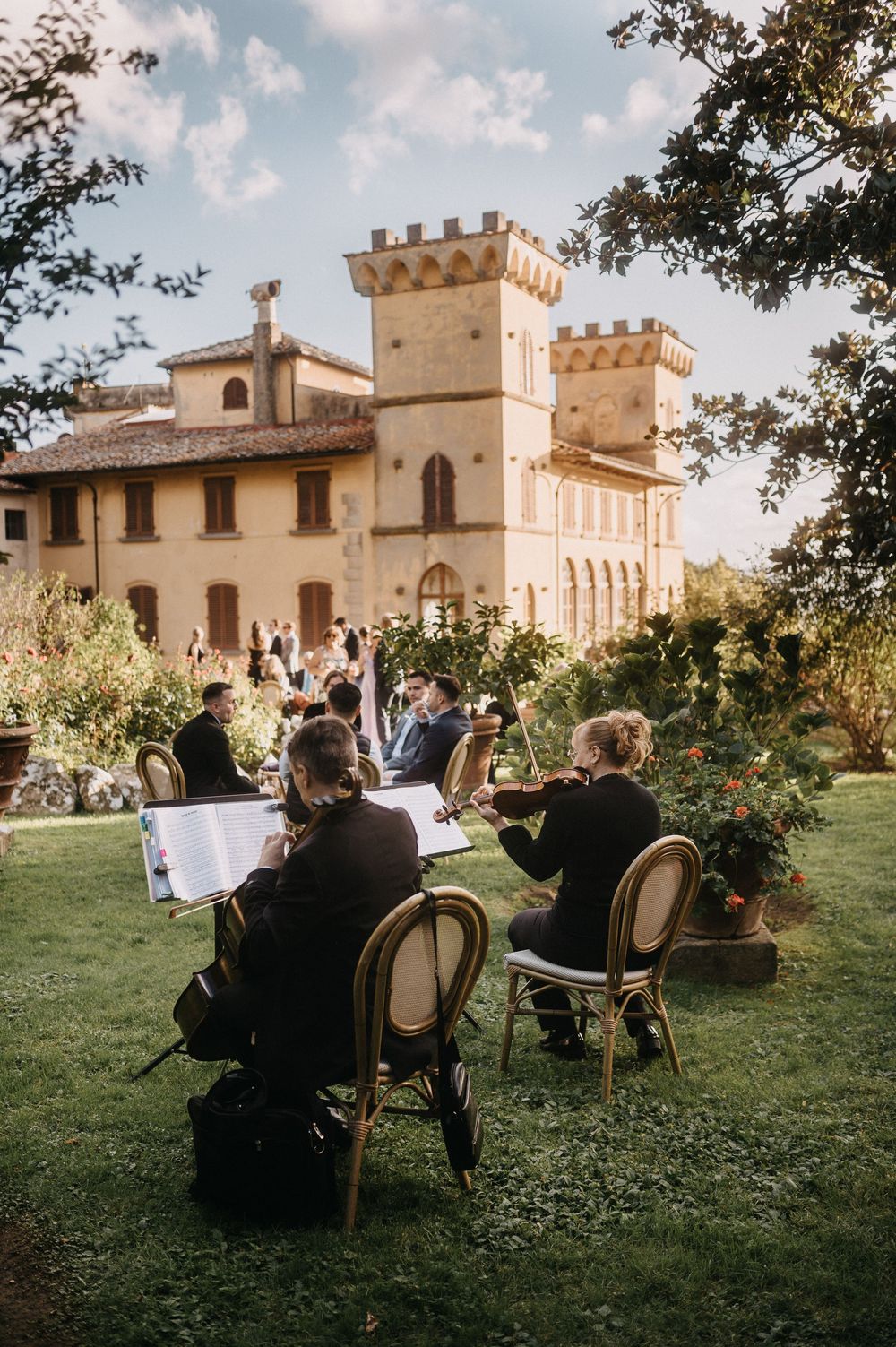Wedding reception at Italian villa with castle-like architecture and elegant outdoor dining setup.