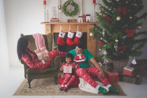 A beautiful Christmas lounge complete with fireplace and stockings, a decorated tree and presents all set to open as a family sits together