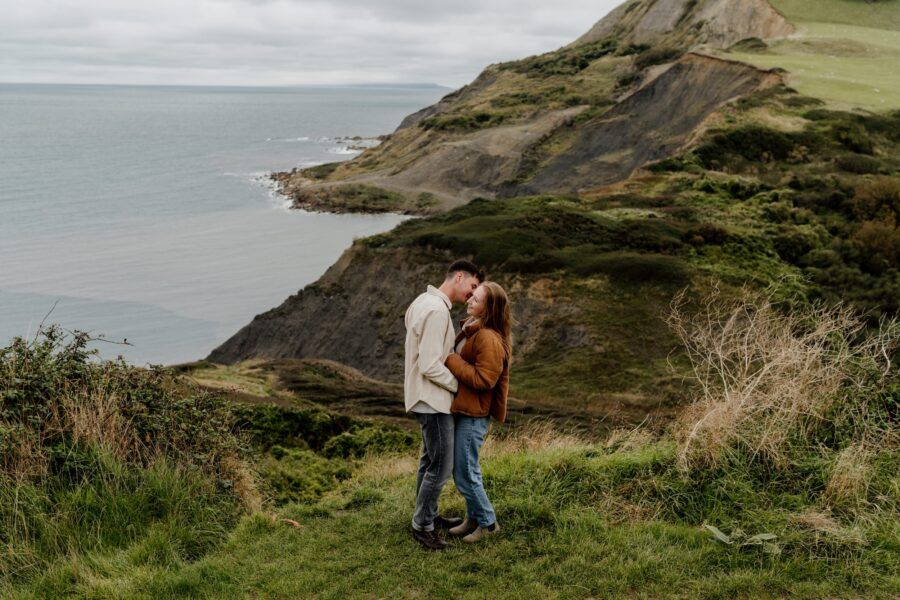 Coastal cliffs and winding paths overlook the dramatic seaside.