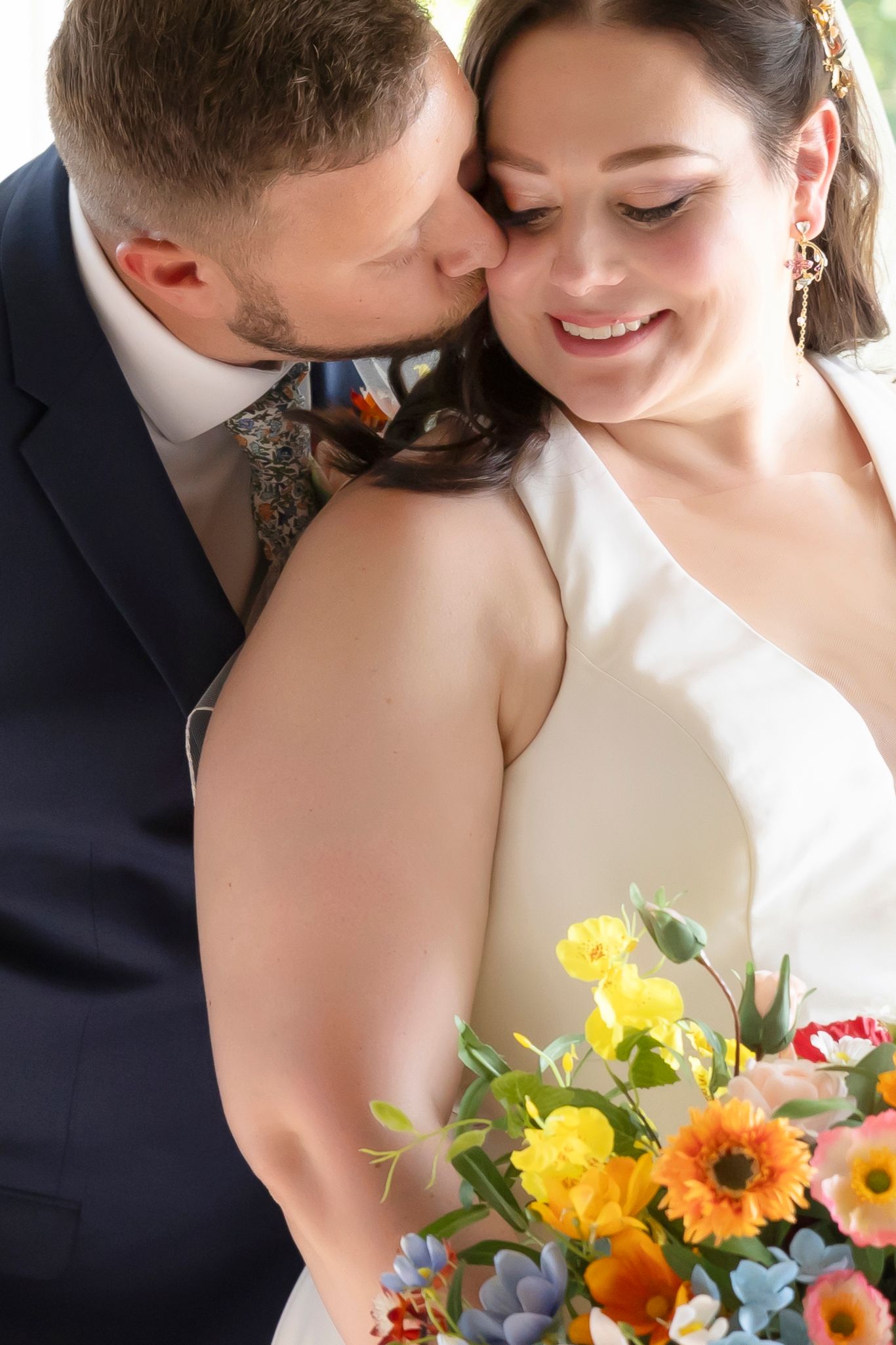 groom kissing brides' cheek micro wedding milestones studios