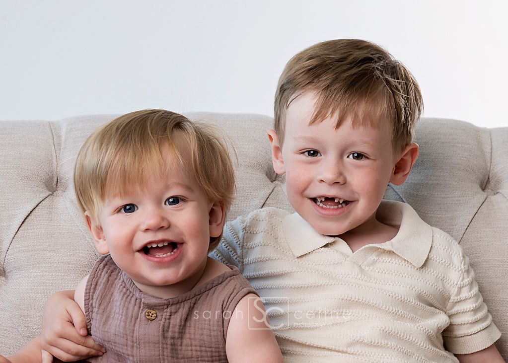 A series of childhood portraits showing cheerful expressions against a light colored background.