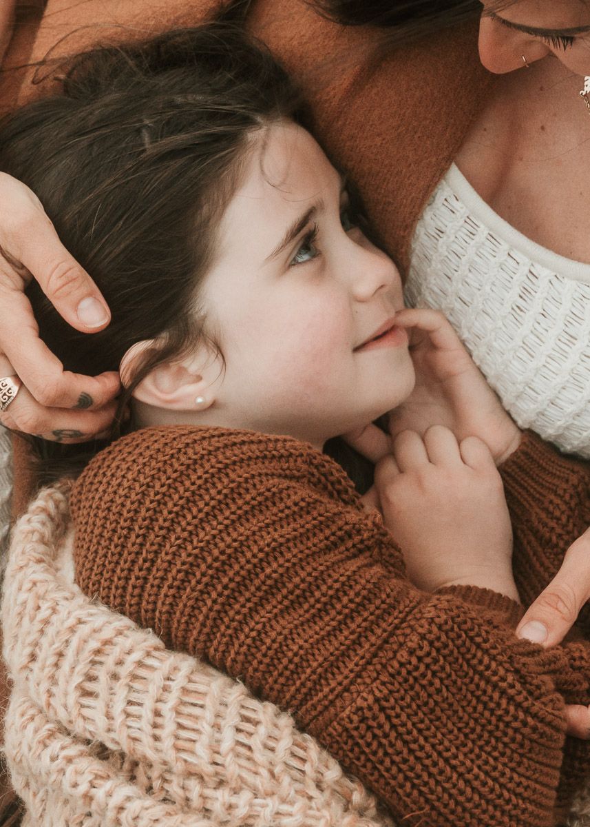 A series of tender moments captured in brown tones showing an intimate embrace between parent and child.