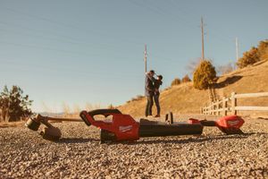 A sunny action sequence of skateboarding tricks on a hillside road captured in multiple sequential frames.