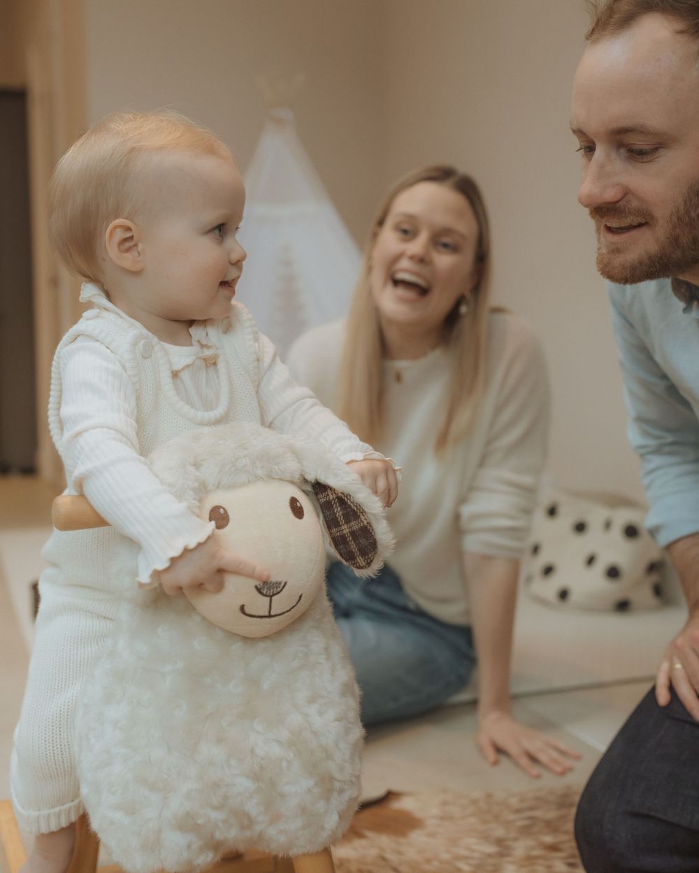 Happy family enjoying playful moments together in their cozy living room.