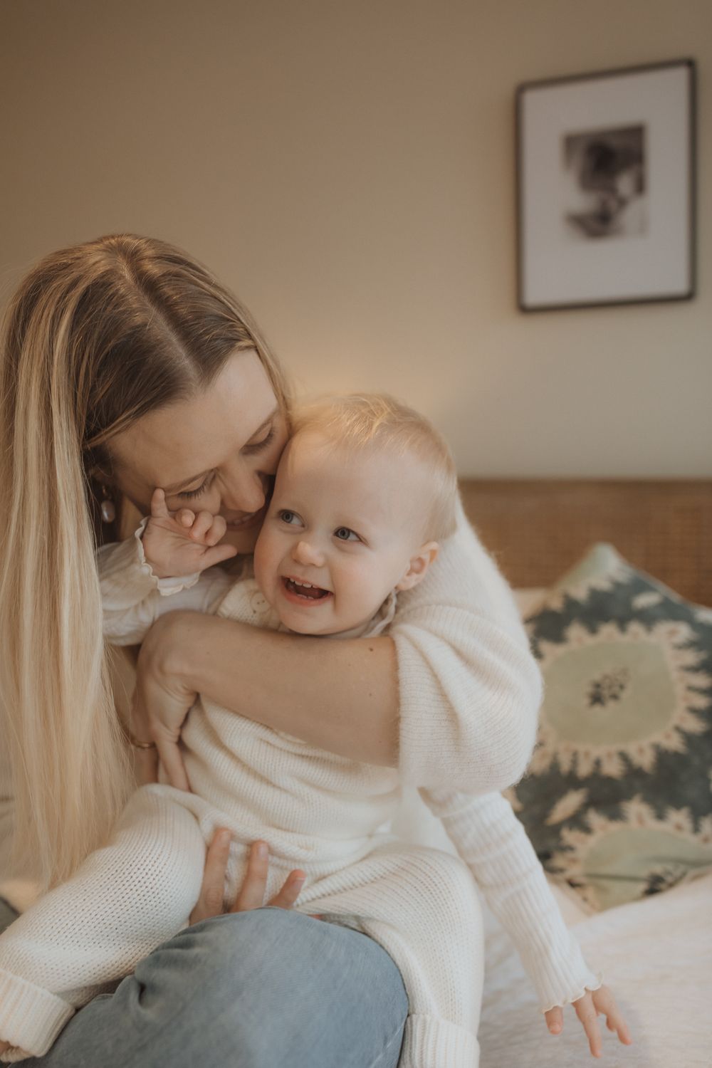 An intimate sequence of parent-child bonding moments in a cozy home setting wearing white sweaters.