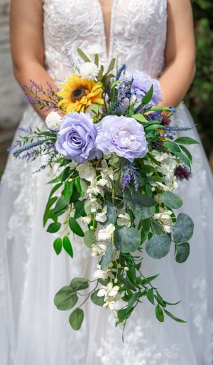 Bridal bouquet series featuring purple roses, sunflowers, and eucalyptus with white florals.