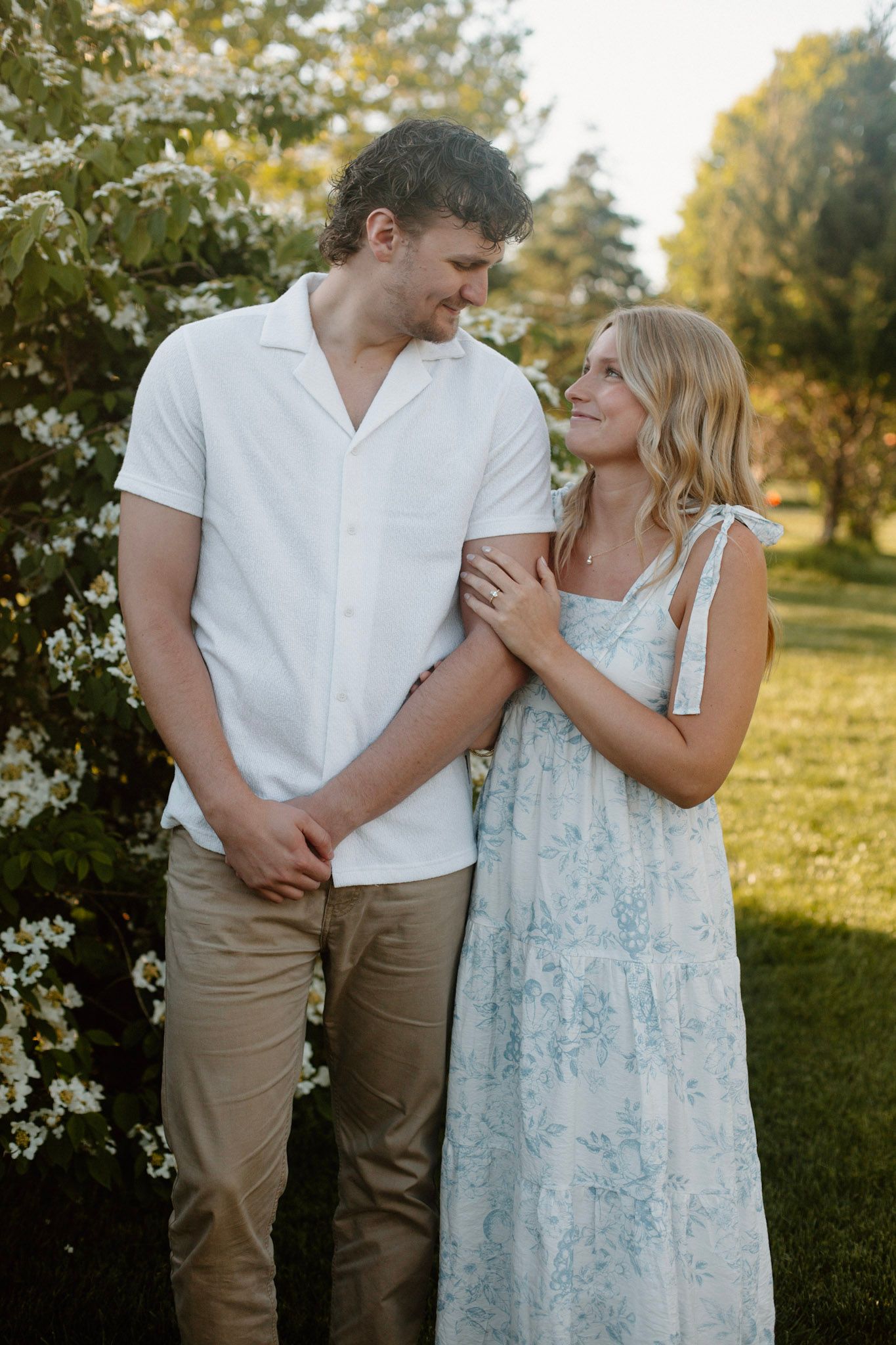 Couplelooking at each other during their engagement session at Millennium Park in Grand Rapids MI.