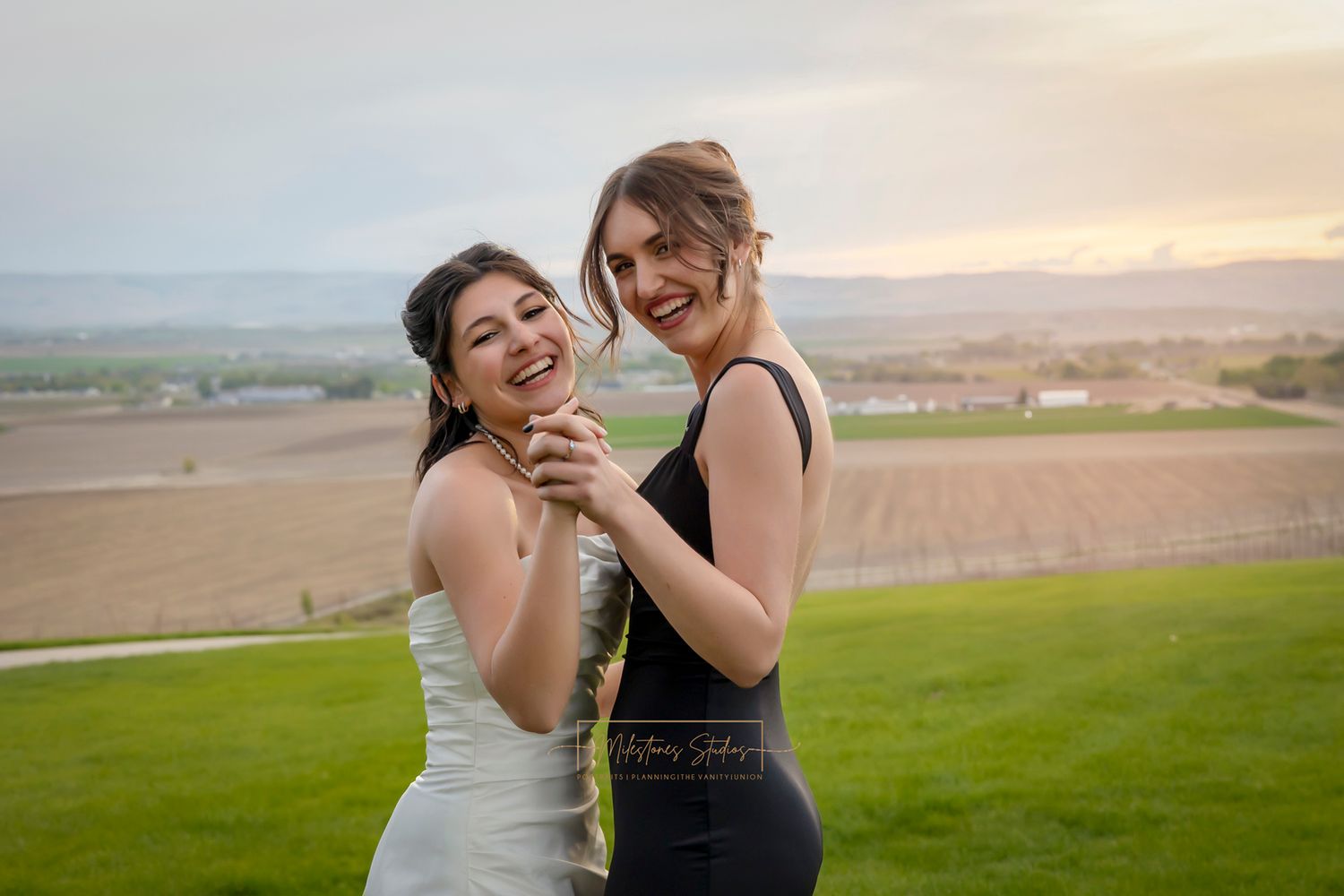 bride and bridesmaid dancing and laughing
