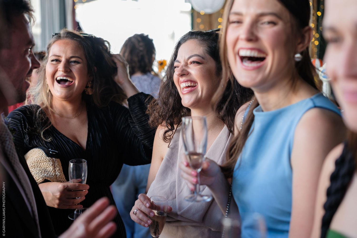 A group of friends enjoying drinks and laughing together at a social gathering.
