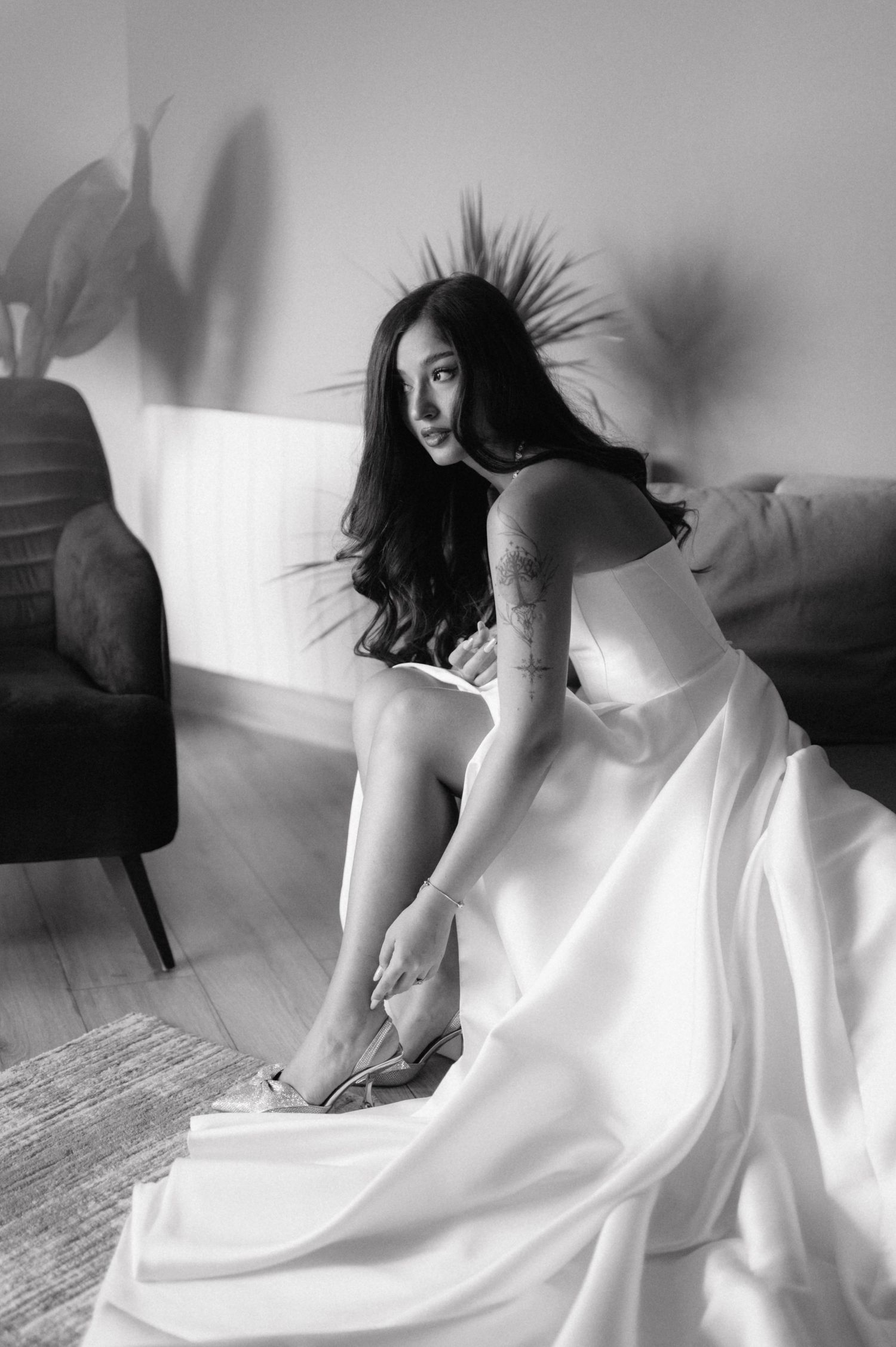 Black and white images show a person in flowing white fabric creating dynamic movement poses against a light background.