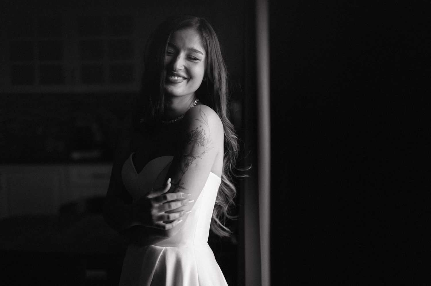 A series of black and white bridal portraits showing romantic poses and flowing dress details in elegant indoor lighting.