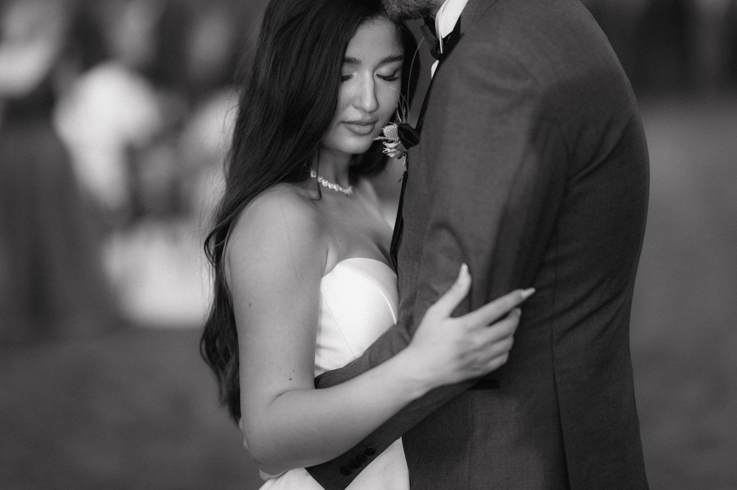 Black and white collage of wedding photos showing intimate embraces between bride and groom during their special day.
