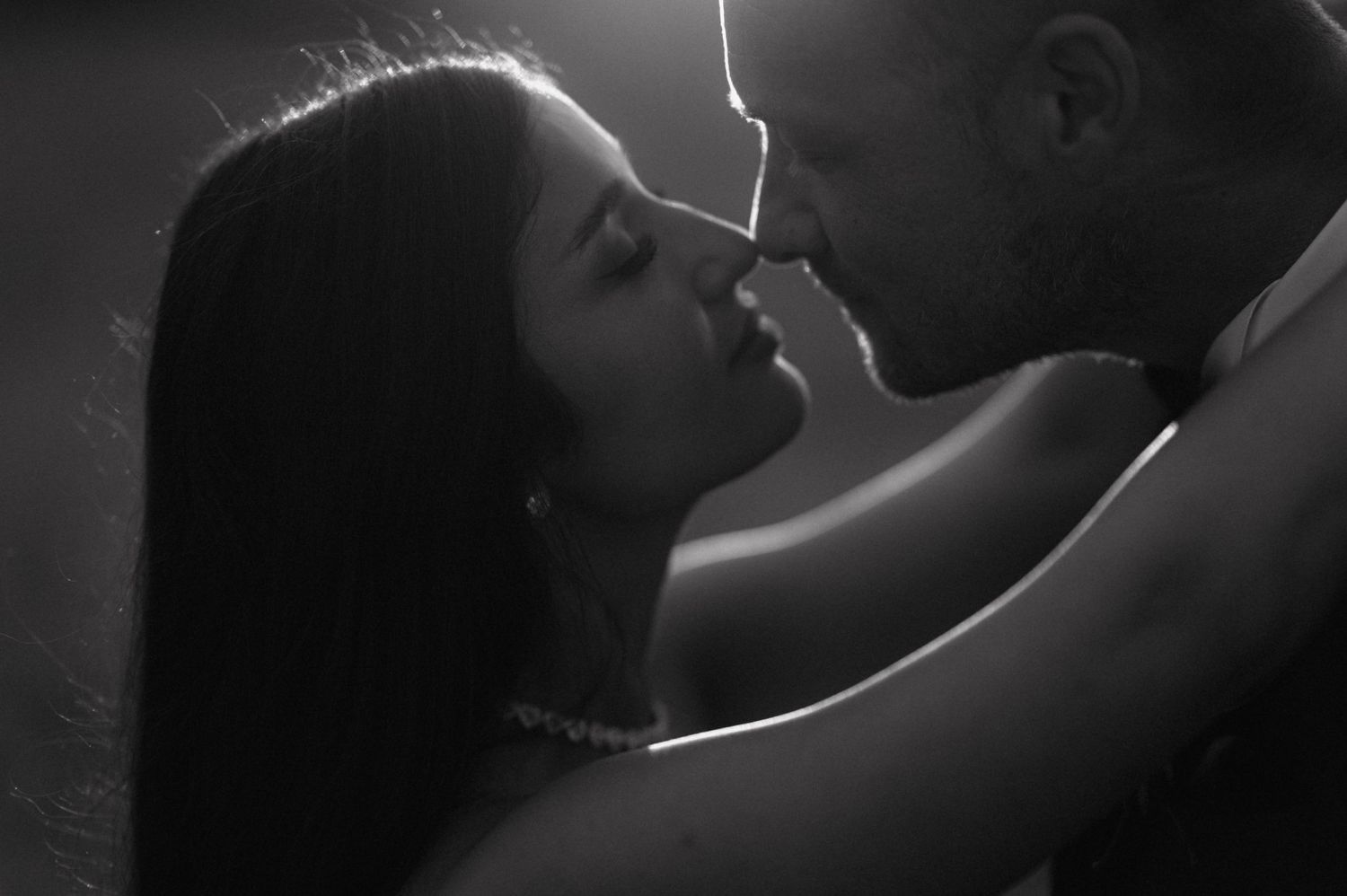 Black and white romantic photos show couples lovingly embracing and kissing in intimate moments.