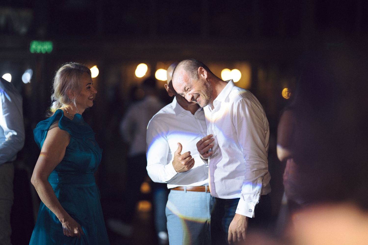 Wedding guests enjoying conversation during the evening reception.