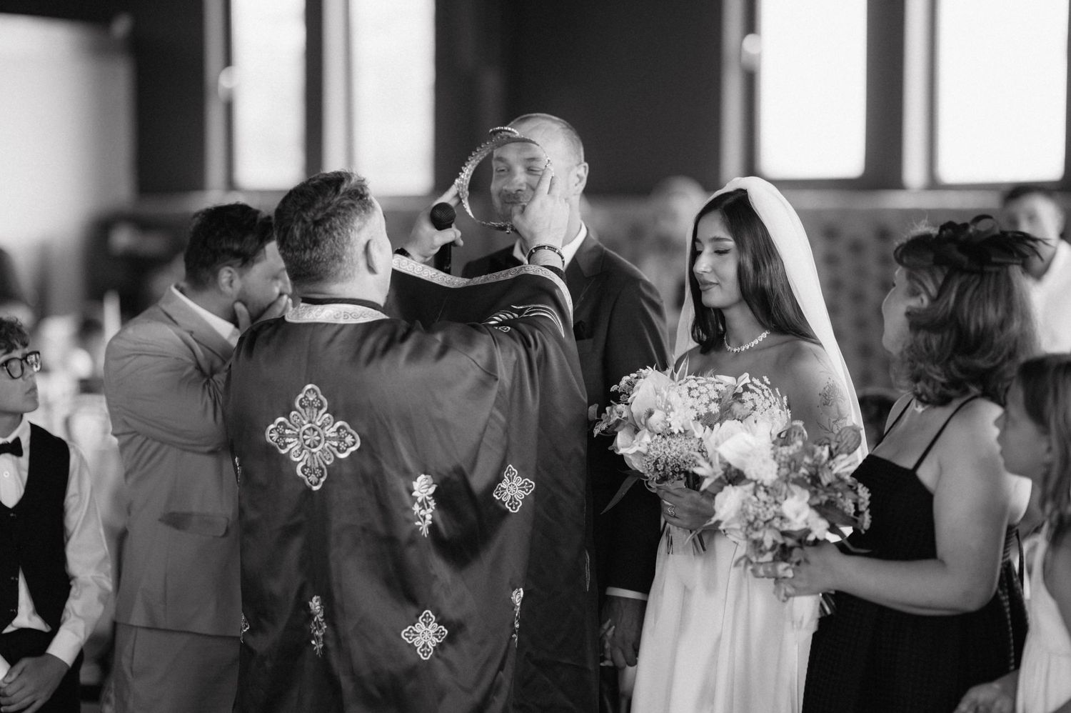 Wedding guests dance in a dimly lit reception venue with Baby's Breath bouquets adding a romantic atmosphere.