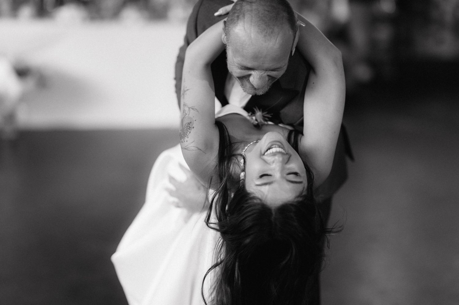 Romantic black and white wedding photo series showing intimate moments between bride and groom in elegant poses.
