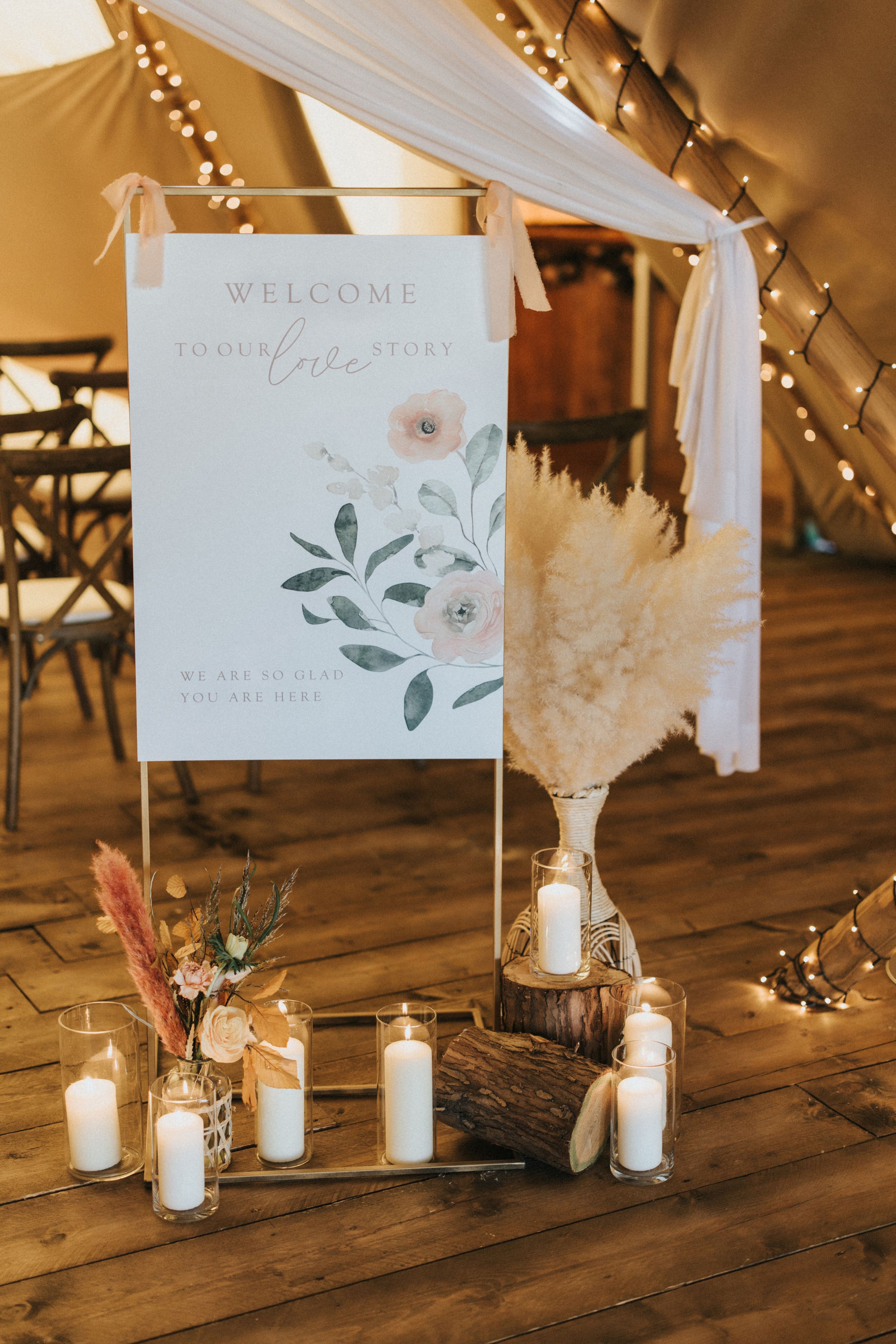 Wedding welcome sign with floral design displayed near pampas grass decor at Nuddock Wood Lake - taken by Grimsby photographers.