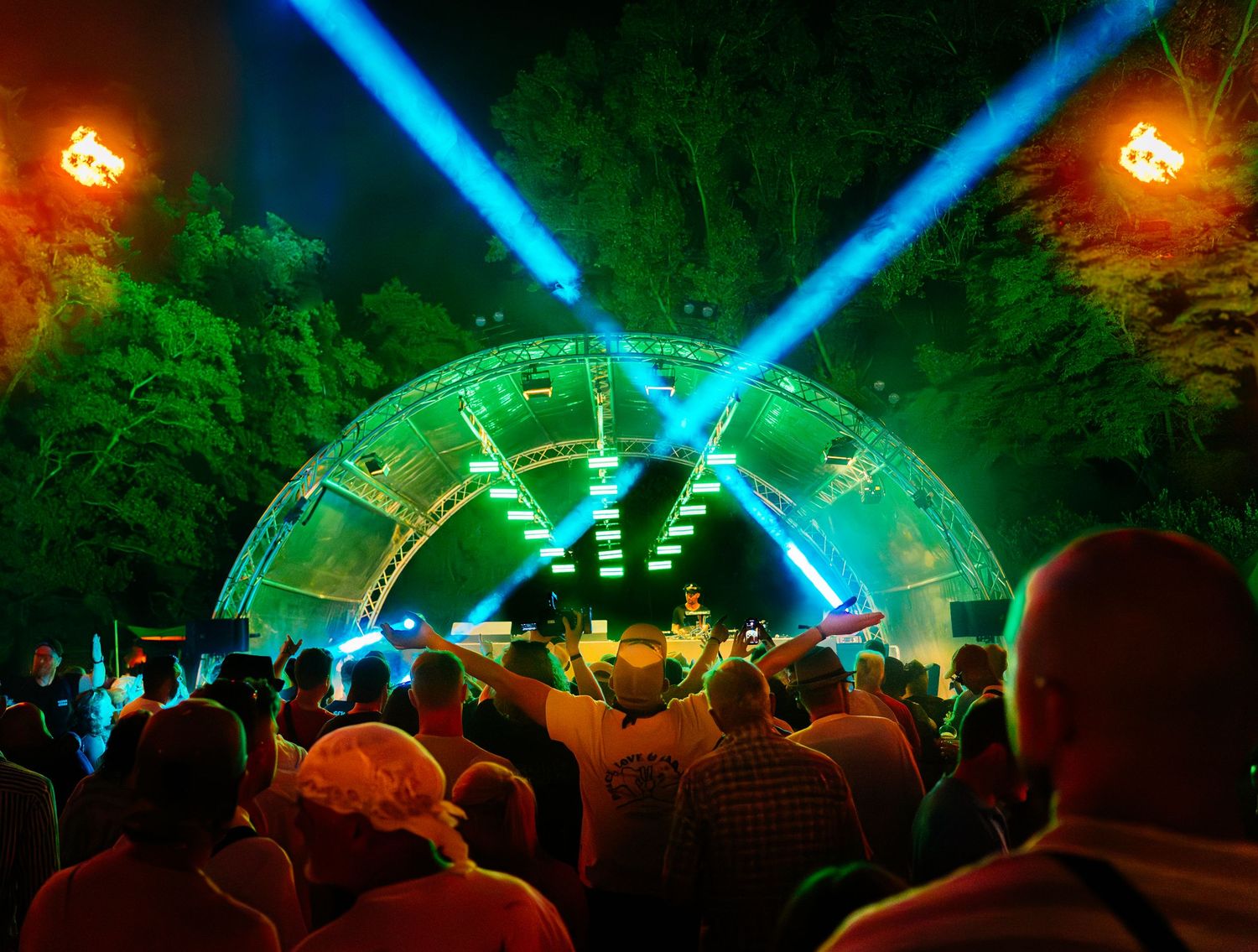 Large crowd of people gathered at a night event or music festival, captured by an event photographer. Amphoria Open Air techno festival