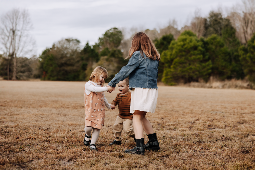 A series of candid outdoor family photographs taken in a rustic field during golden hour.