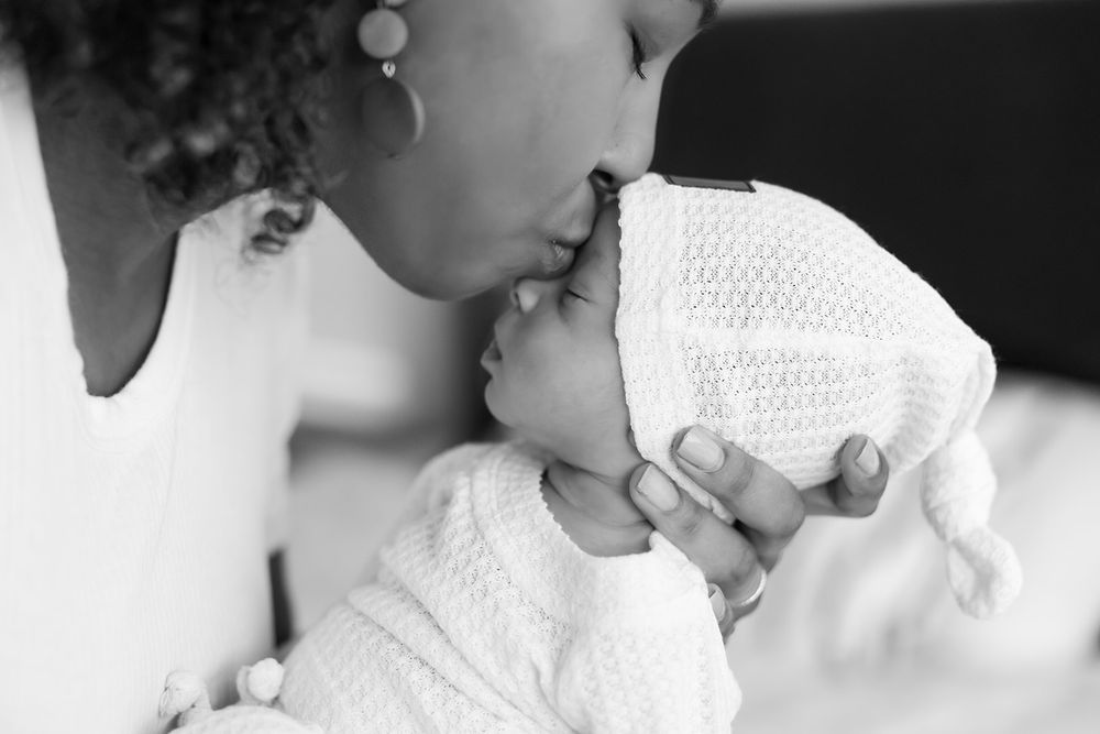 A collection of black and white photos showing children in candid moments with soft lighting and intimate expressions.