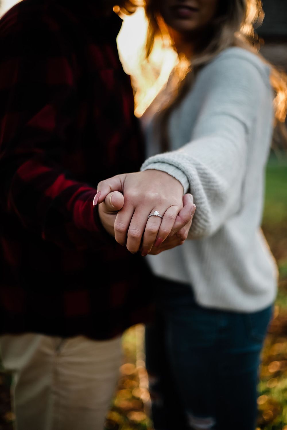 Romantic engagement session of a joyful couple outdoors with natural light in North Carolina. Ring shot.