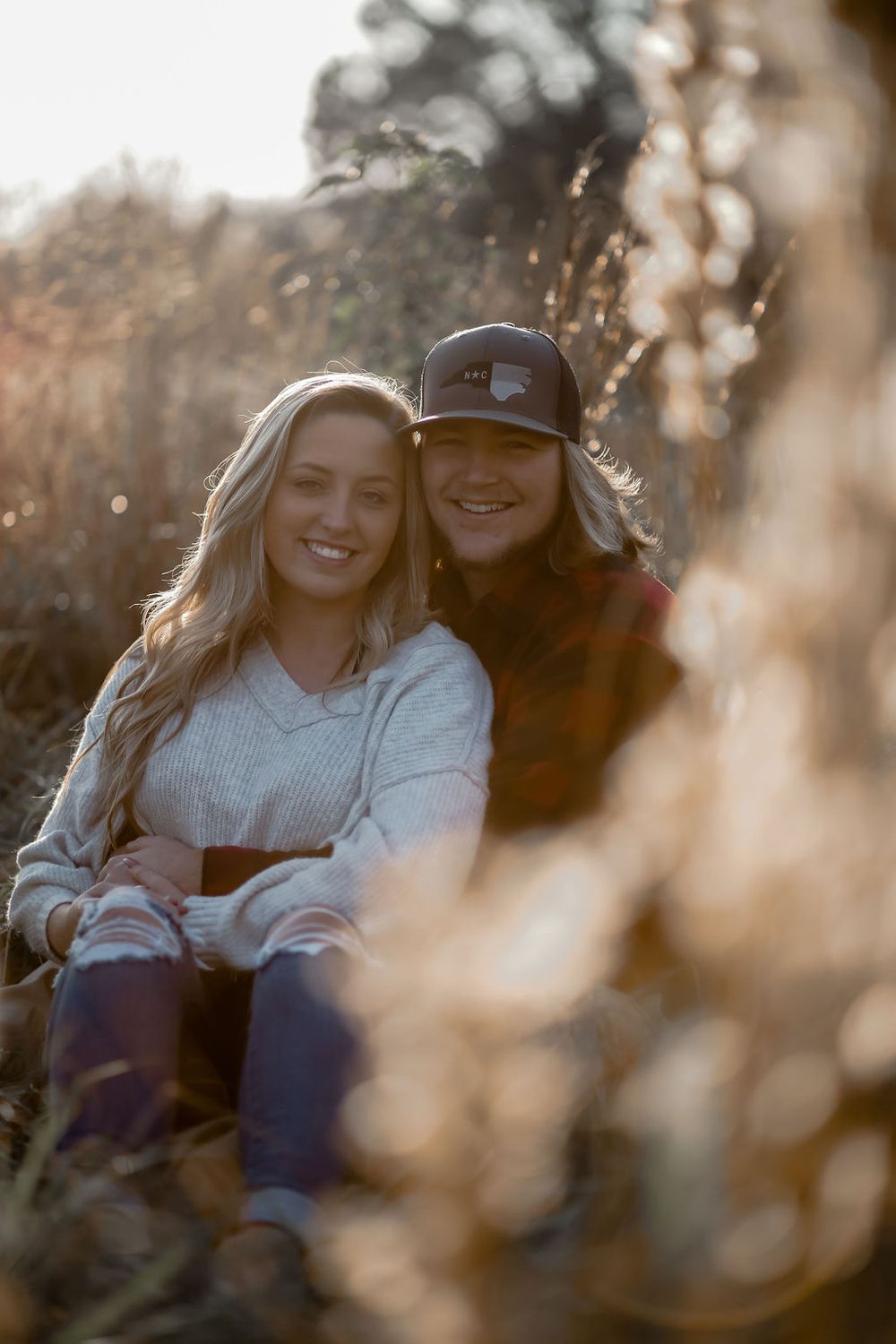 Casual engagement session of a joyful couple outdoors with natural light in North Carolina.