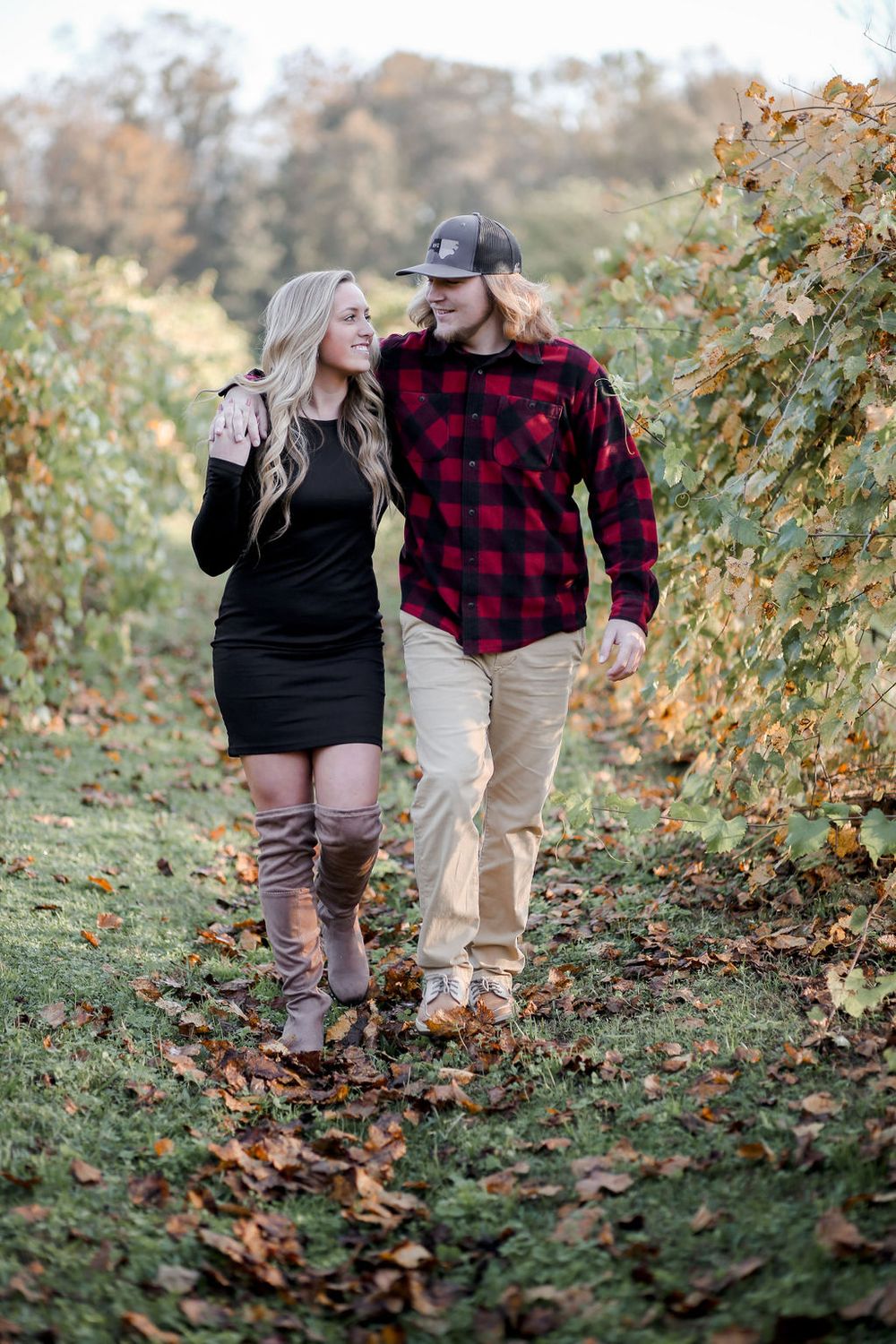 Romantic engagement session of a joyful couple outdoors with natural light in North Carolina.
