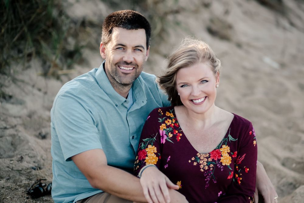 Romantic engagement session of a joyful couple outdoors with natural light in North Carolina.