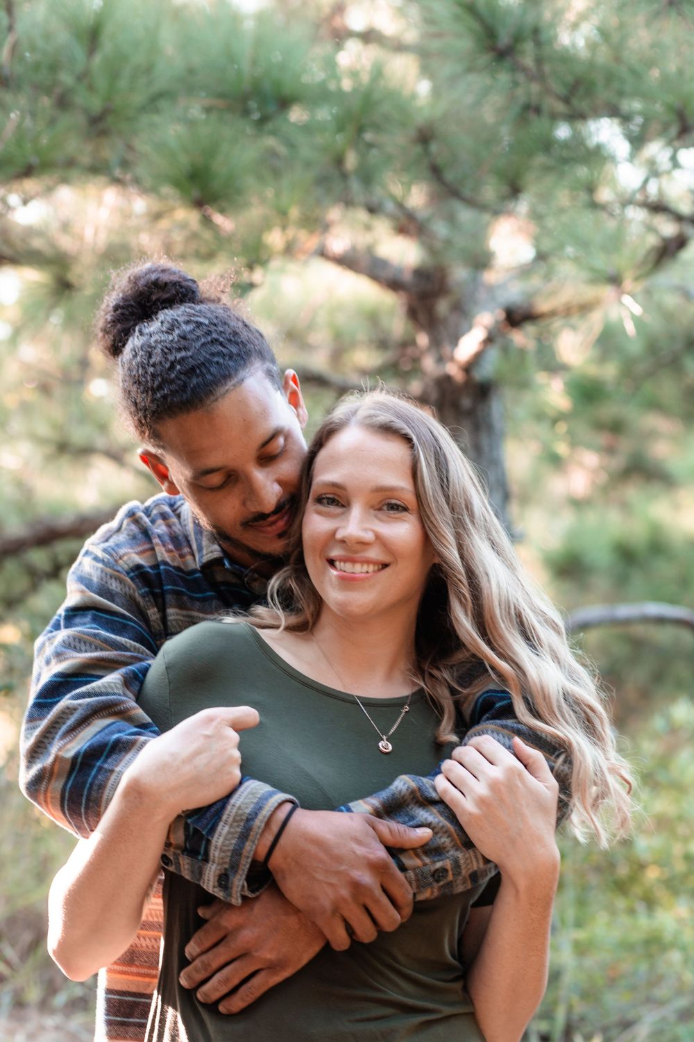 Casual engagement session of a joyful couple outdoors with natural light in North Carolina.