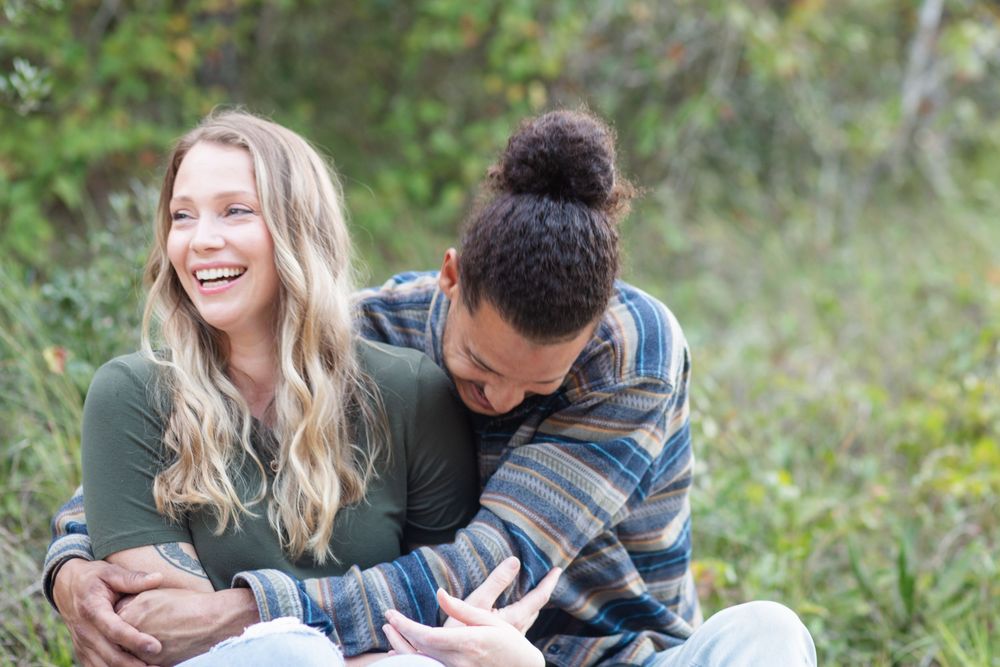 Casual engagement session of a joyful couple outdoors with natural light in North Carolina.