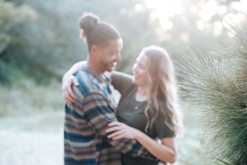 Casual engagement session of a joyful couple outdoors with natural light in North Carolina.