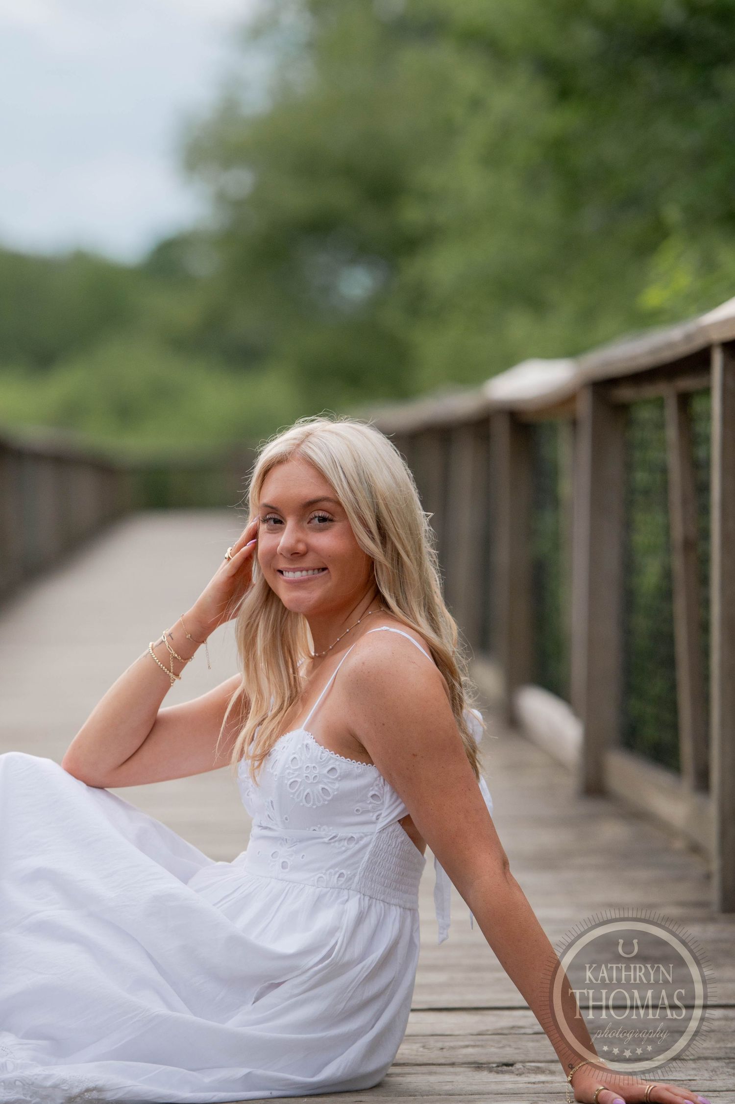 Black and white portrait series of a bride in a white dress posing outdoors in a natural setting.